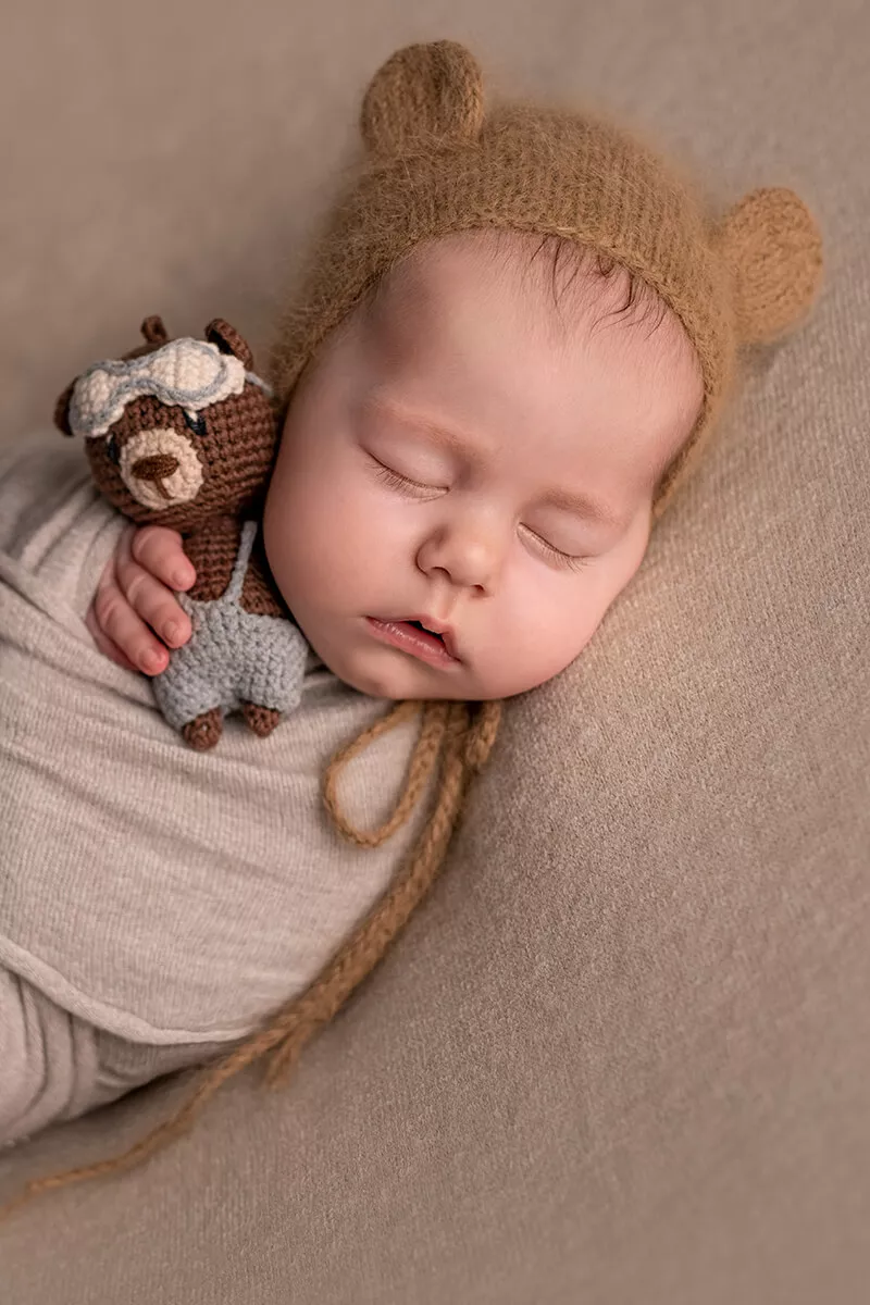 Newborn baby photographed during a full posed studio-style session